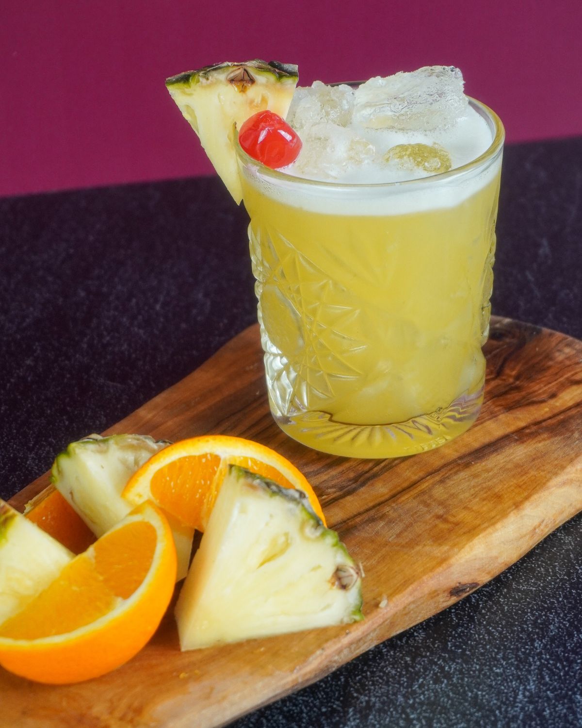 Pineapple Rum Punch with pineapple and orange wedges for garnish