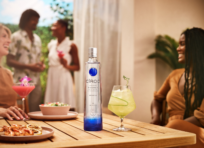 Bottle of Ciroc vodka beside cocktail