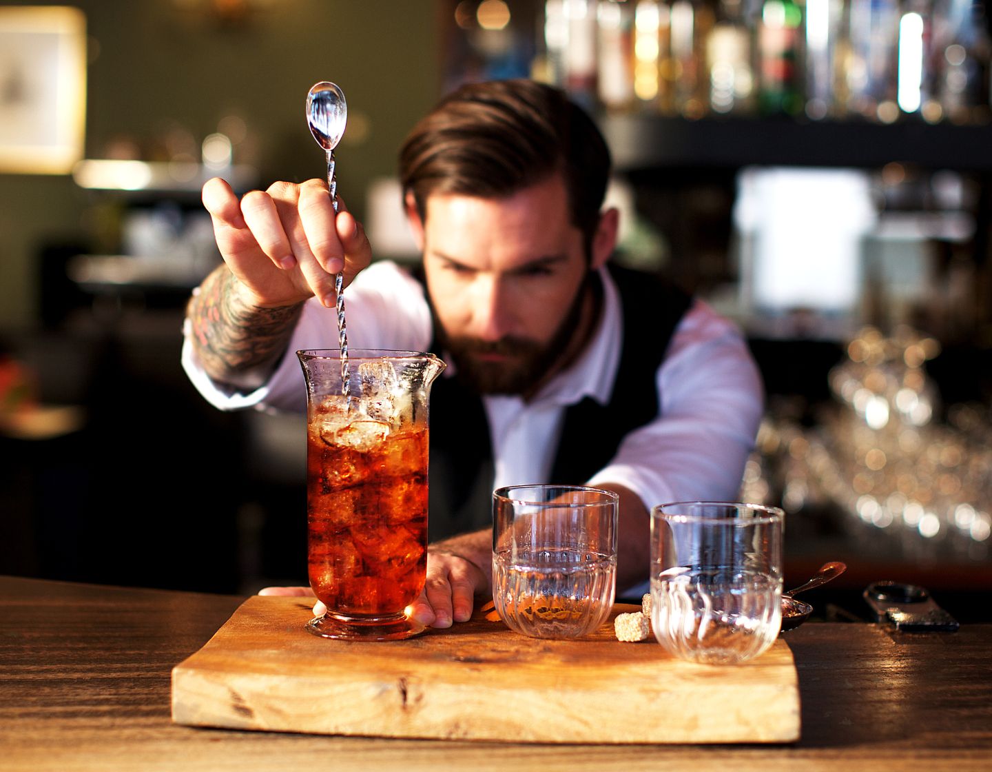 Hombre revolviendo una bebida en un bar