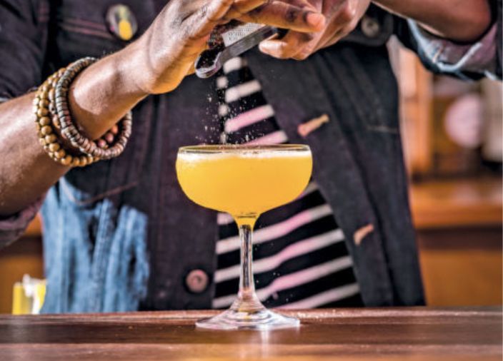 One Love Cocktail being poured from shaker into coupe glass