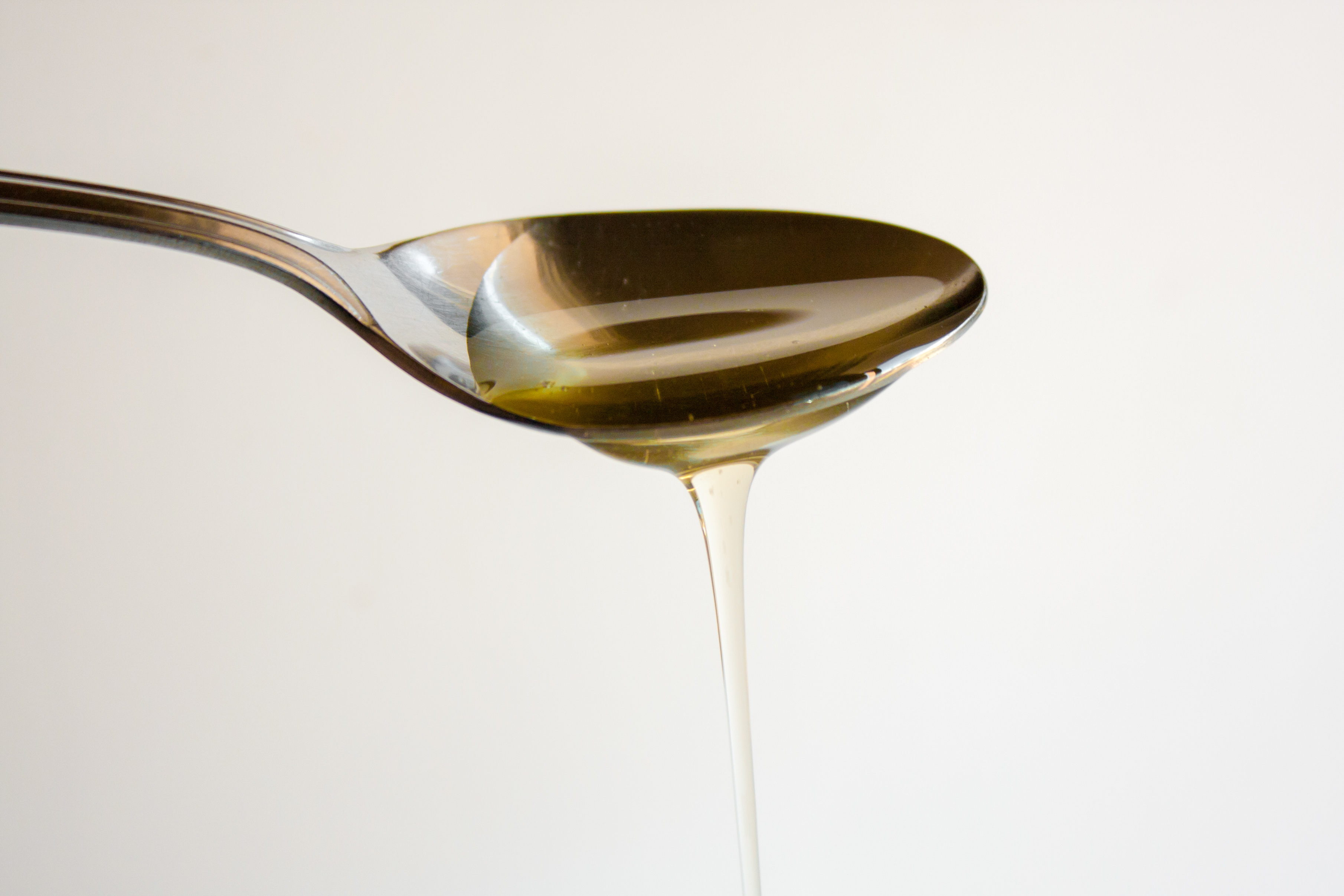 Close up of syrup being poured onto spoon