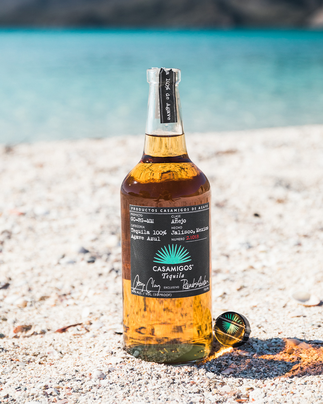 Cocktail bottle on a beach