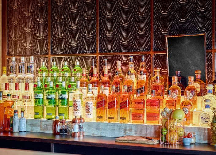 Backbar of Diageo branded bottles neatly organised
