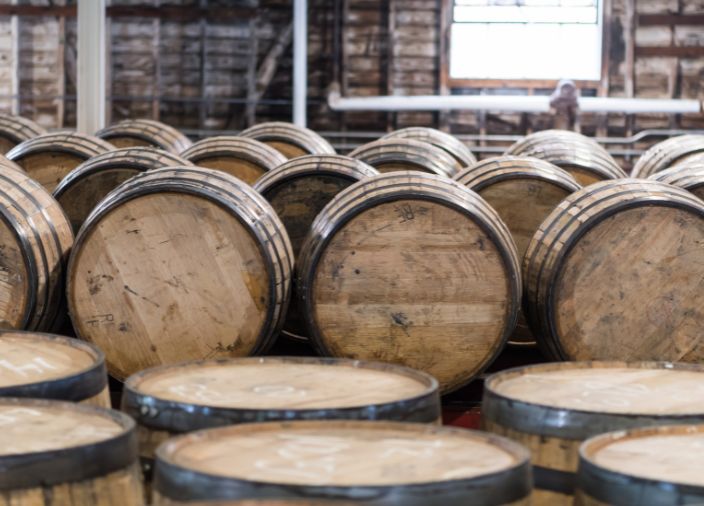 Multiple whisky barrels stacked during maturation