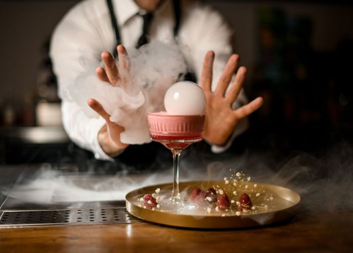 Bartender creating a smoky cocktail