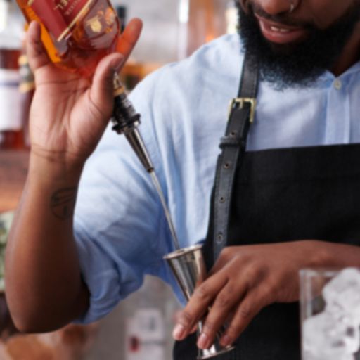 Man pouring Spirit into jigger featuring Johnnie Walker Red Label