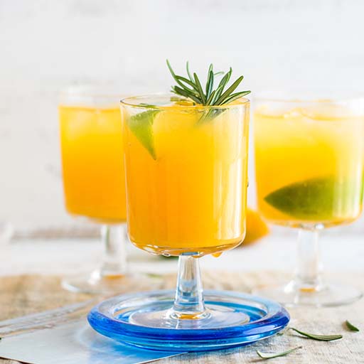 Three cocktail glasses of batch cocktails 