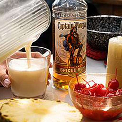 Bottle of Captain Morgan and frozen cocktails in a pitcher