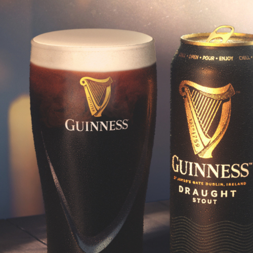 Pint of Guinness Draught in glass beside can of Guinness Draught Stout