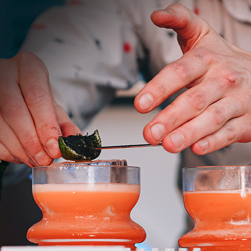 Bartender setting garnish on a cocktail