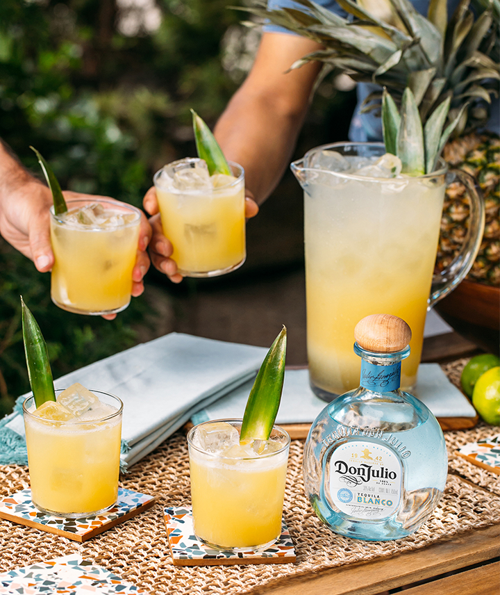 Cocktails, a pitcher of cocktails, and a bottle of Don Julio