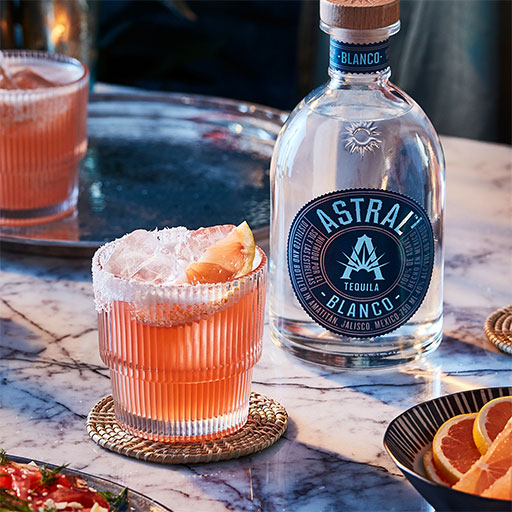 Bottle of Astral tequila with cocktails