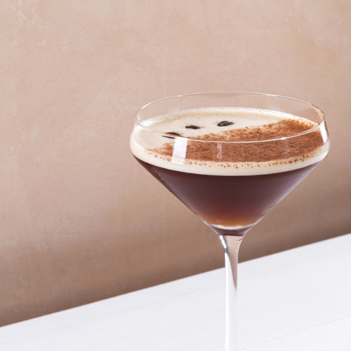 Single espresso martini topped with cocoa powder and coffee beans 