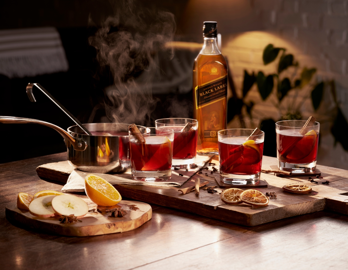 Cocktails on a tray with bottle of Johnnie Walker whisky