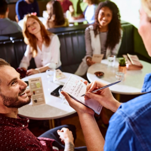 Waiter_taking_customers’_order_with_notepad