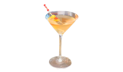 An orange-tinted martini cocktail with a red and orange pickle garnish, and a bottle of Don Julio tequila on a wooden table.