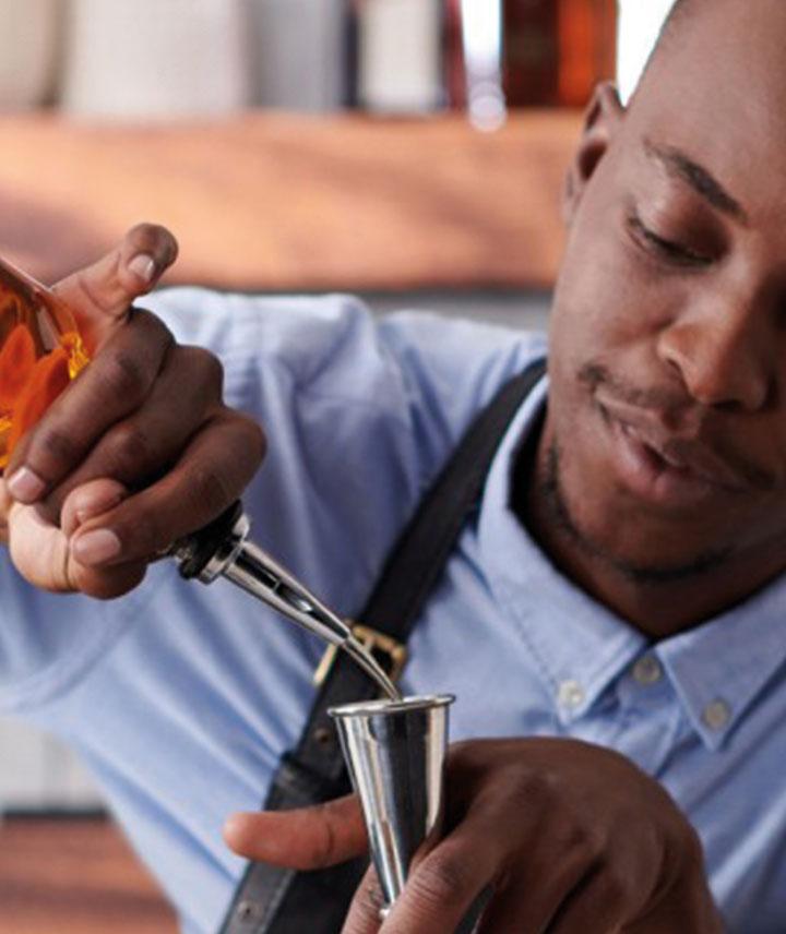 server pouring a whisky