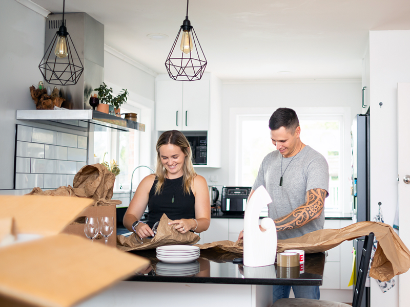 Two young people decluttering their home.