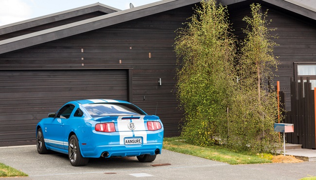 blue car pared in front of house