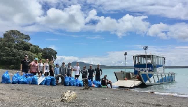 group with full beach clean up bags