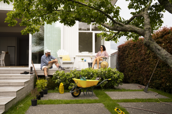 Two people sitting in the garden of their house