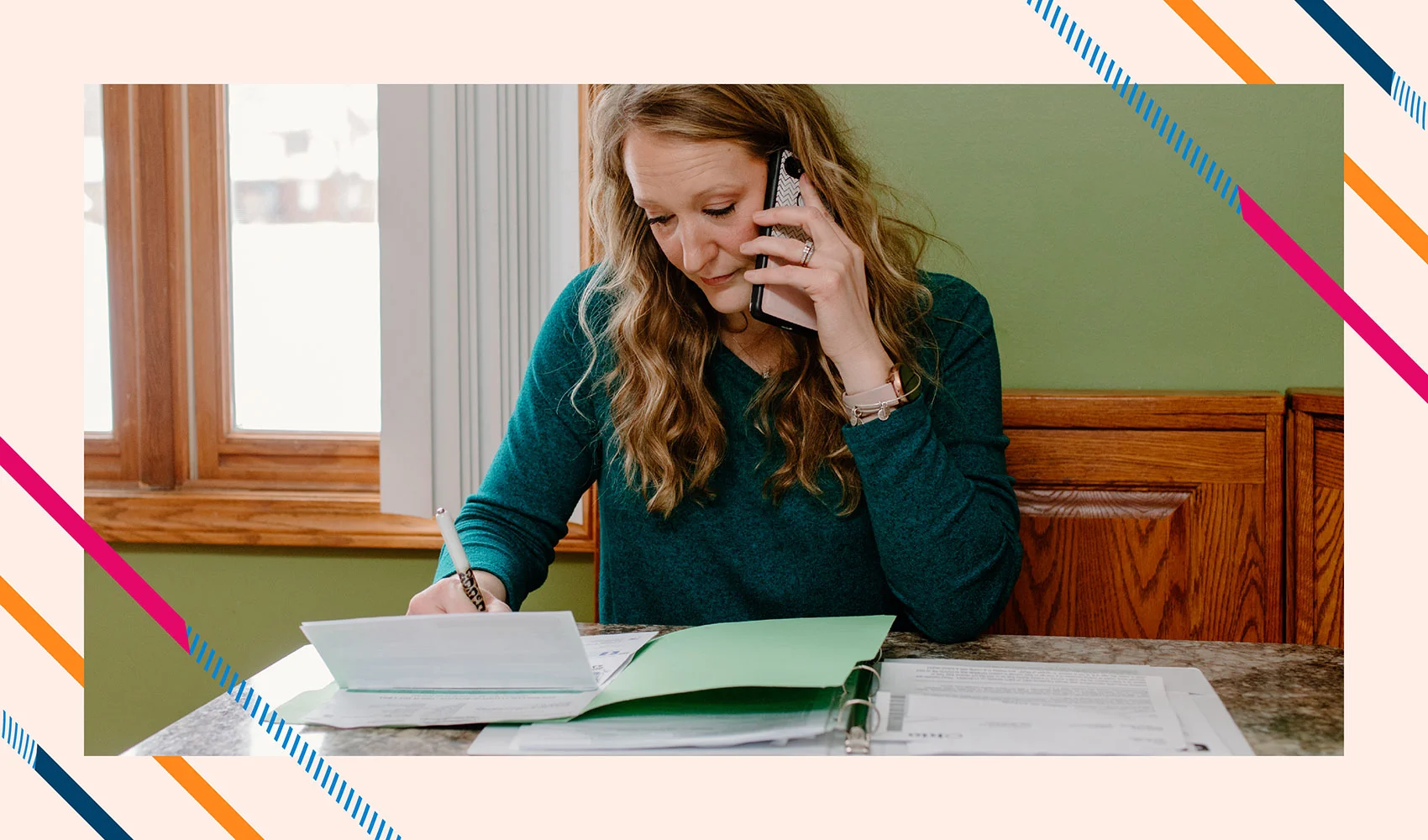 Kristy on the phone looking at paperwork in the access header image
