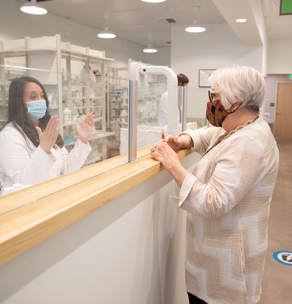 Joan chats behind the pharmacy counter