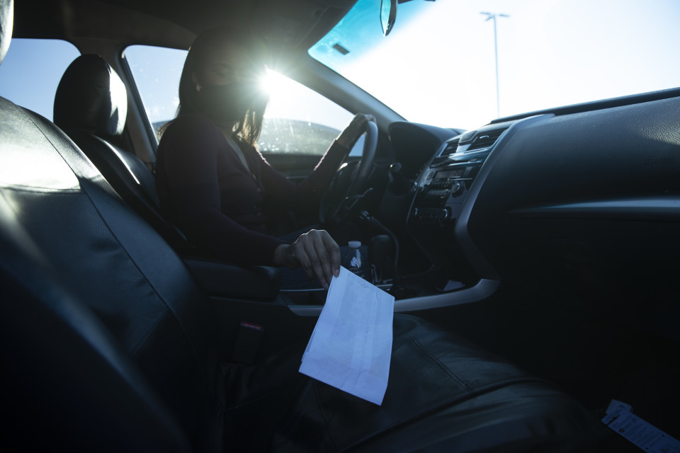 Tonia picks up a prescription from the pharmacy in her car