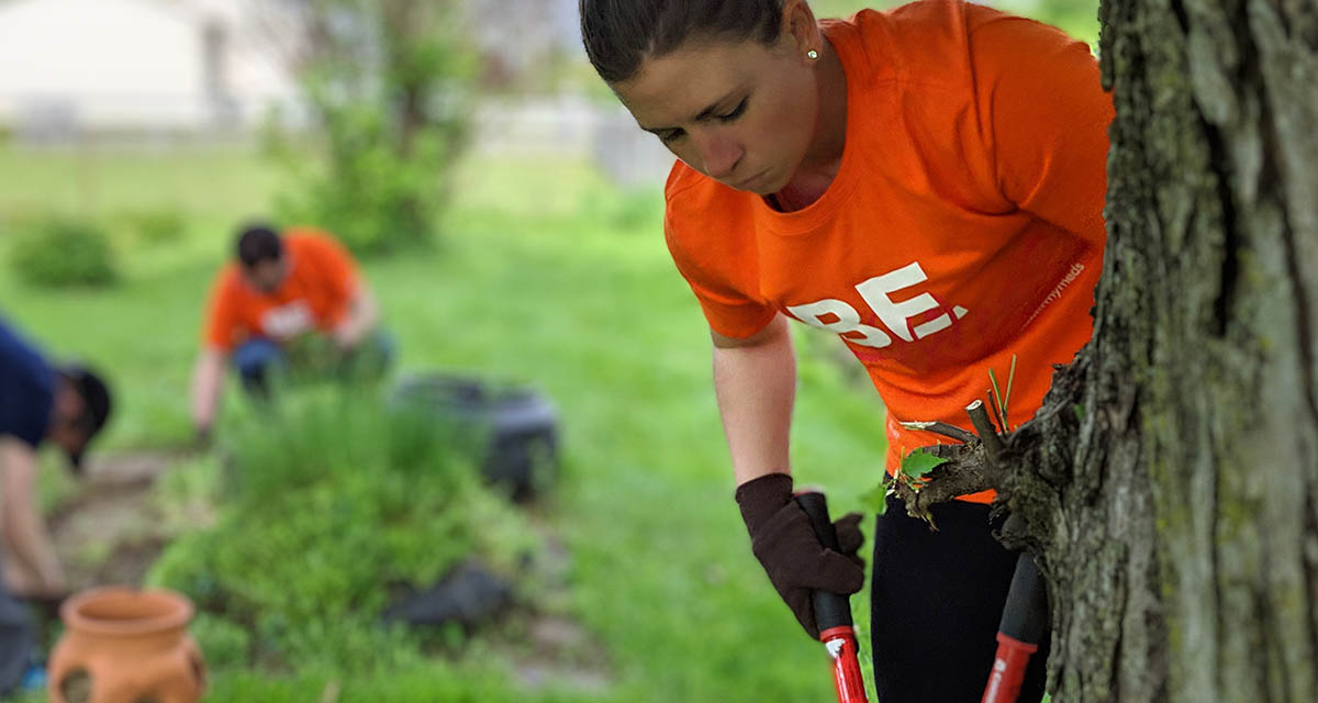 A CoverMyMeds employee volunteering her time landscaping 