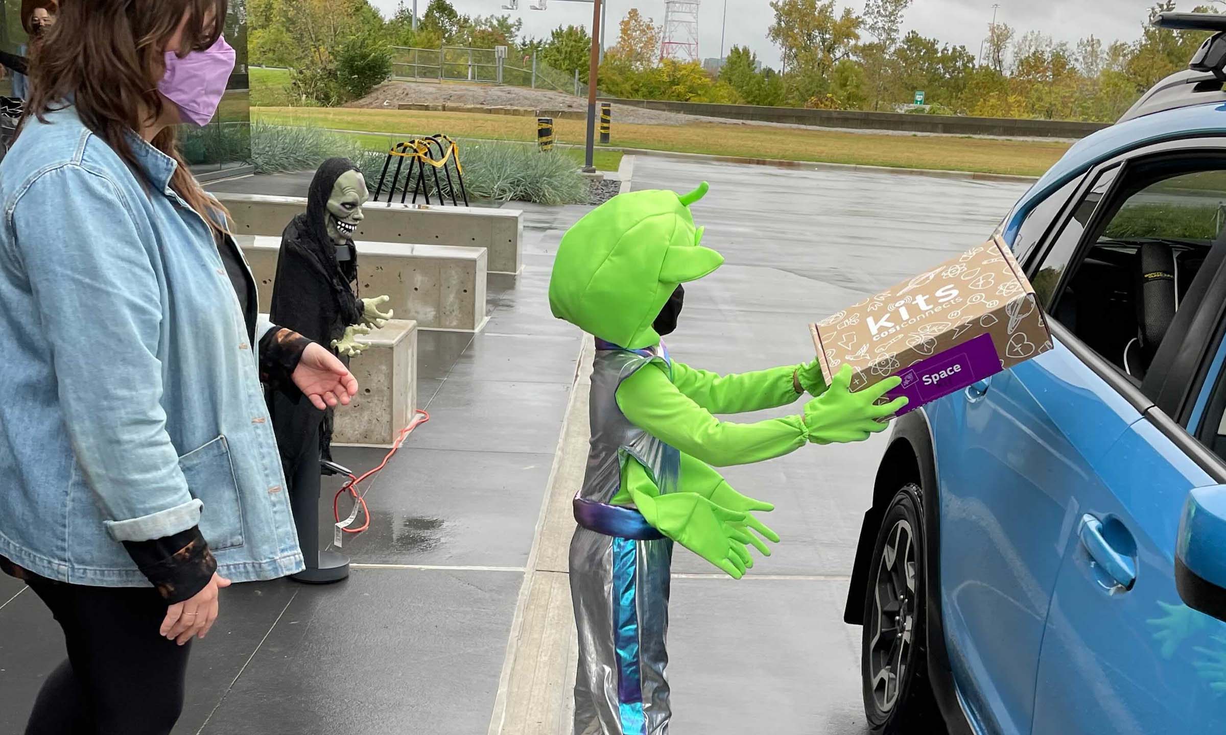 CoverMyMeds employees hand out COSI Connects Space Kits to kids on Halloween