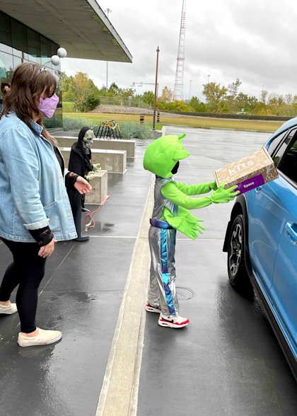 CoverMyMeds employees hand out COSI Connects Space Kits to kids on Halloween