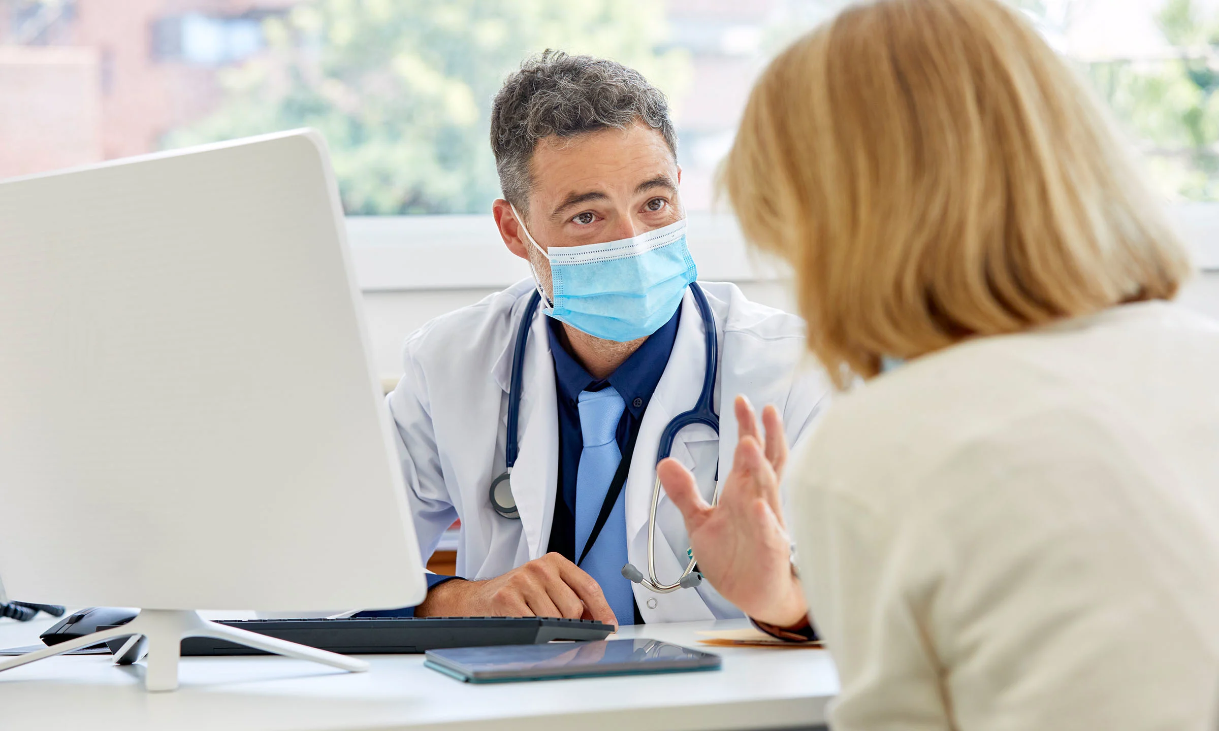  Greater adoption of digital health tools, or healthcare technology, can positively impact medication access, affordability and adherence for patients —  and the entire healthcare network. Here, a doctor discusses a health matter with their patient.