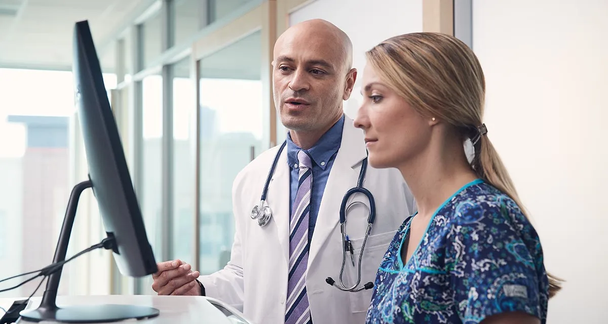 Doctor and nurse meet in front of a computer