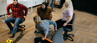 A match of office chair fútbol during CoverMyOlympics. 