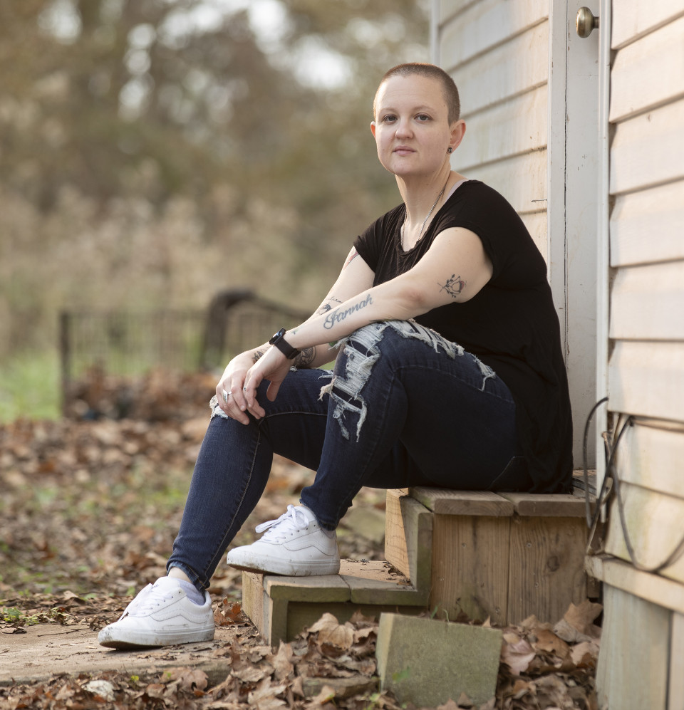 Ashley sits outside her rural Georgia home