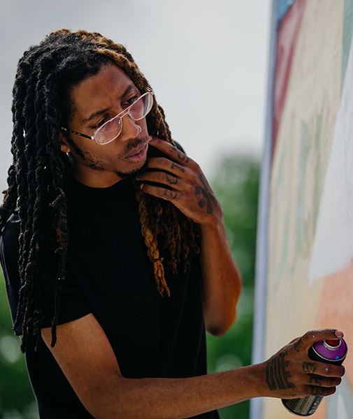 Columbus artist Hakim Callwood working on his Black Lives Matter mural