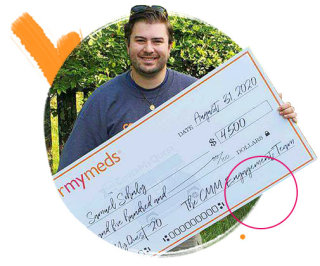Samuel poses for a picture with his CoverMyQuest grant check.