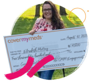 Elizabeth poses for a photo with her quest grant check.