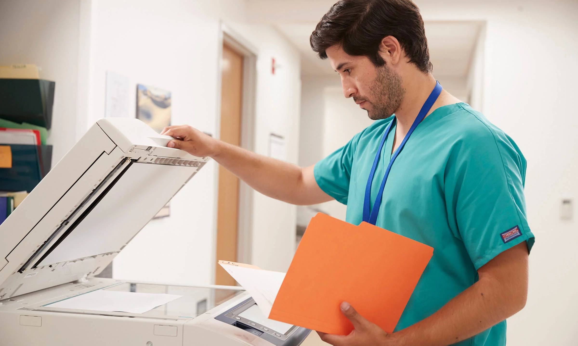 A nurse using a fax machine