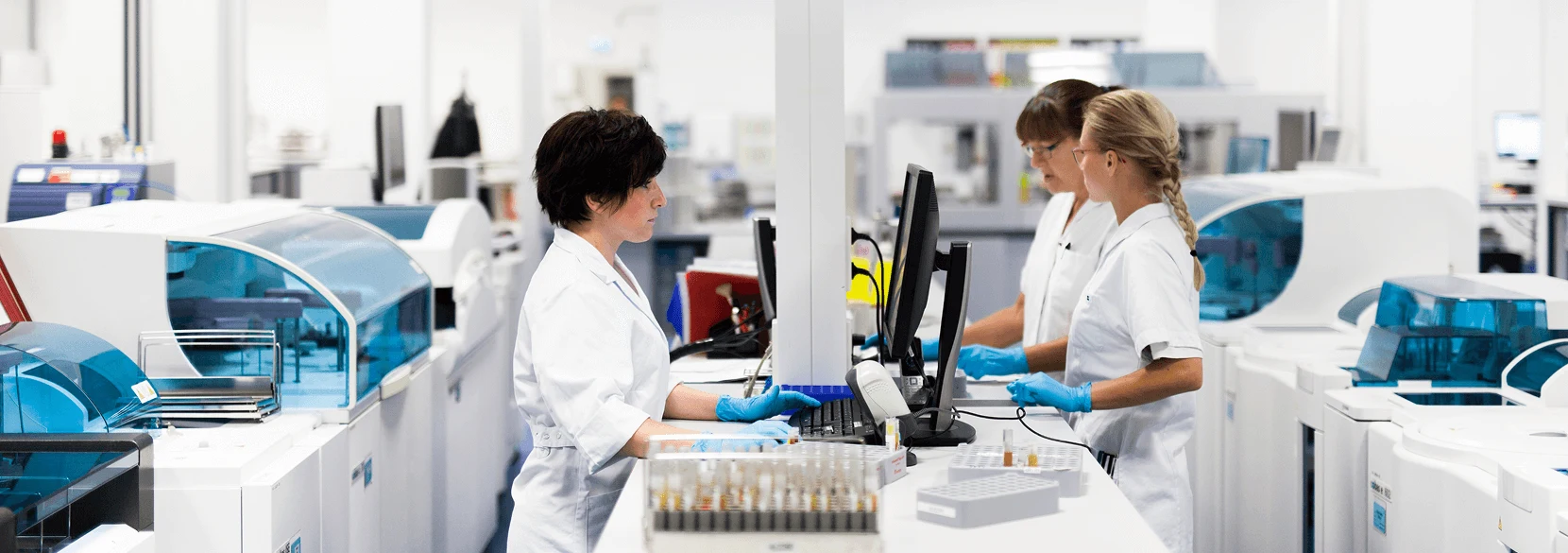 Three female research technicians in a lab