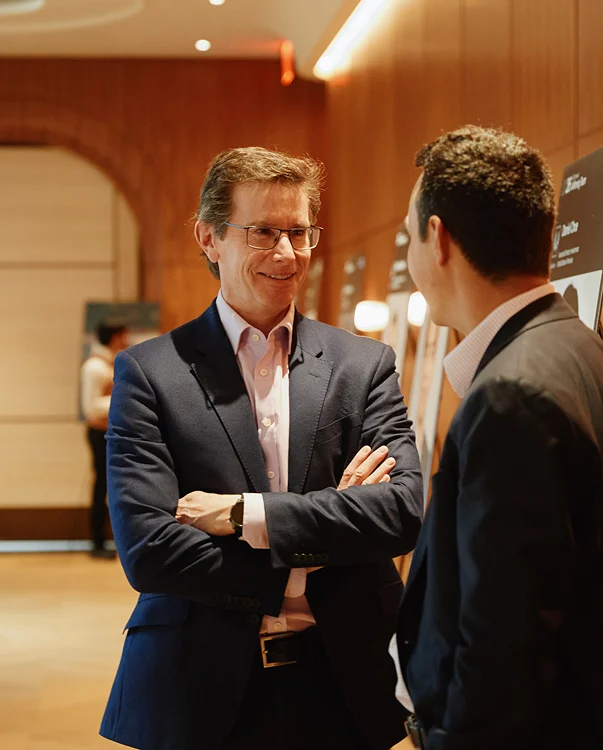Two people standing a wooden hallway