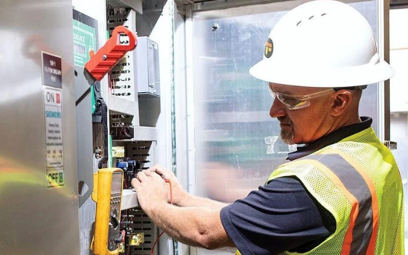 A Modigent worker working on a panel