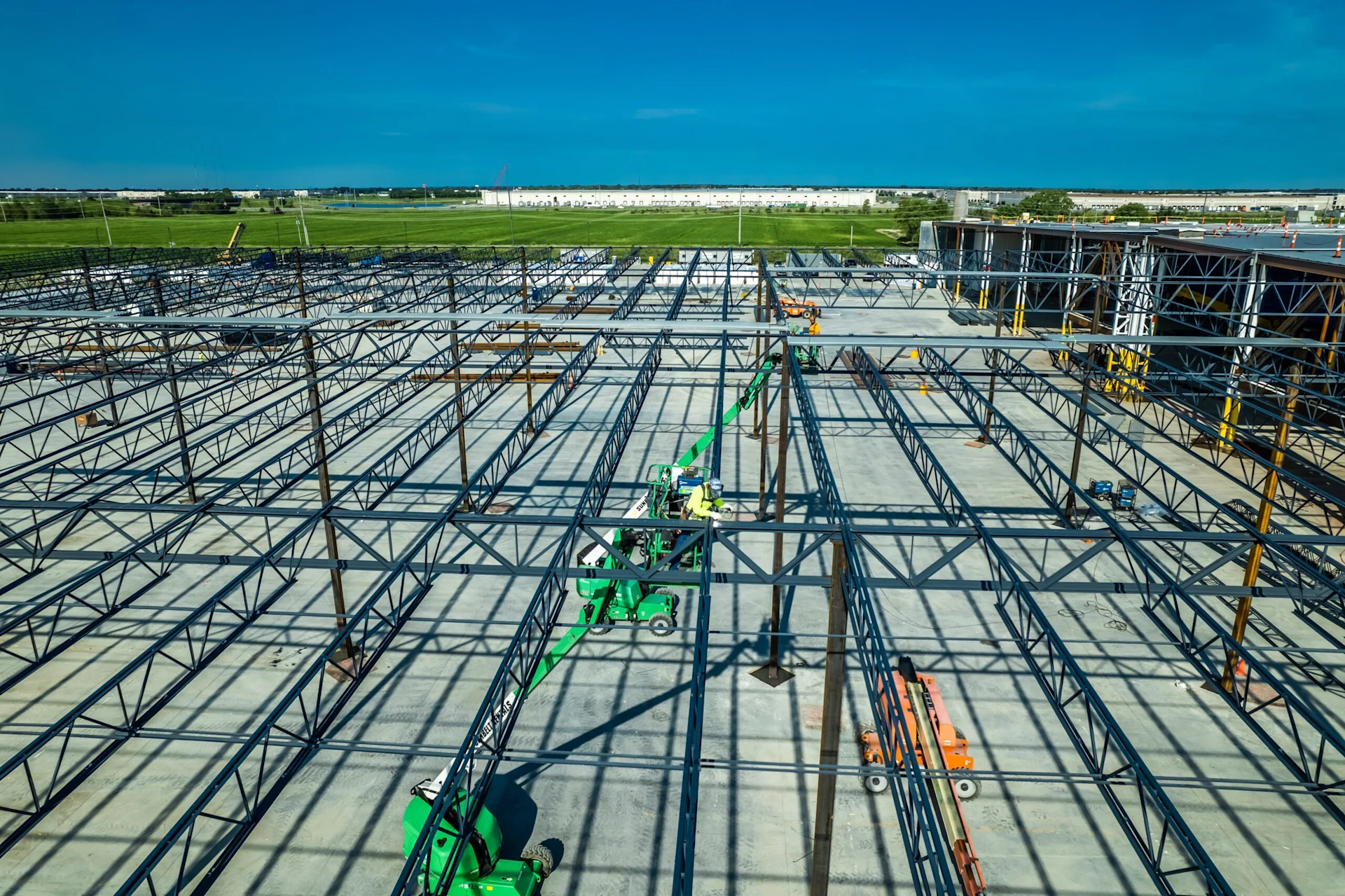 Metal scaffolding over an empty concrete lot