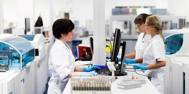 Three female researchers in a lab