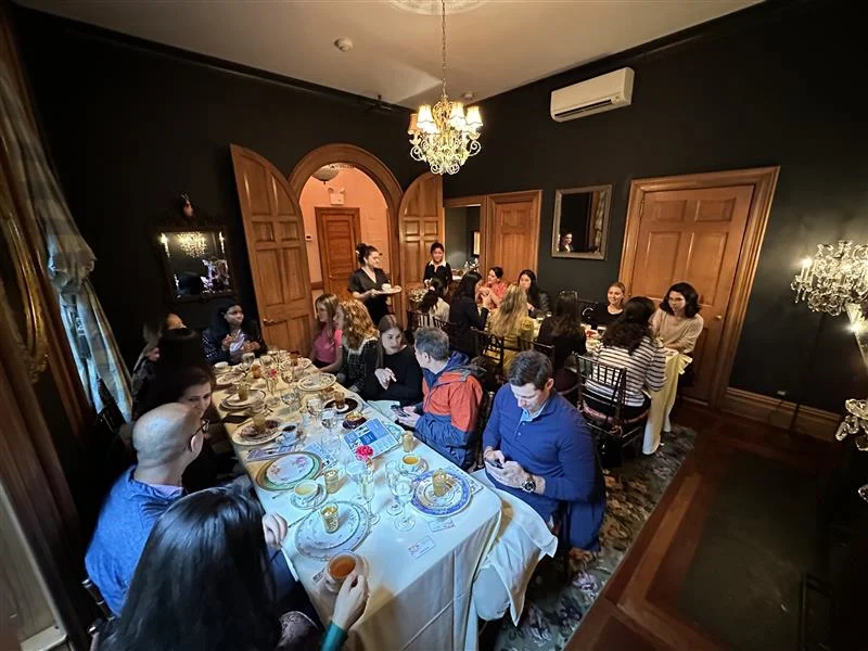Two tables full of people in a dining room