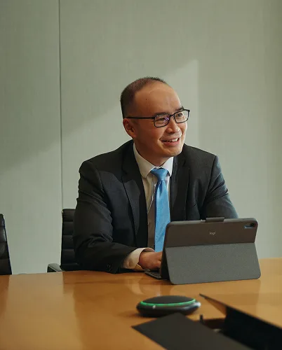 A man sitting at a table with an ipad