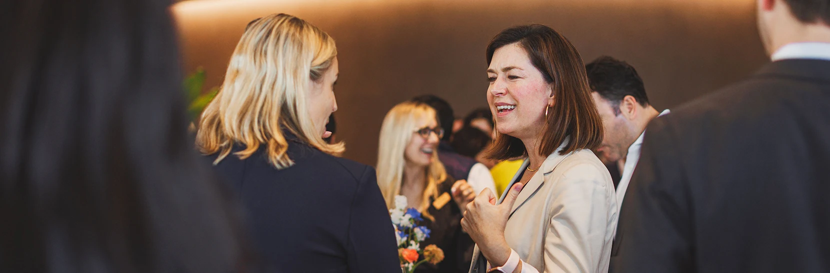 Two women talking in a crowd