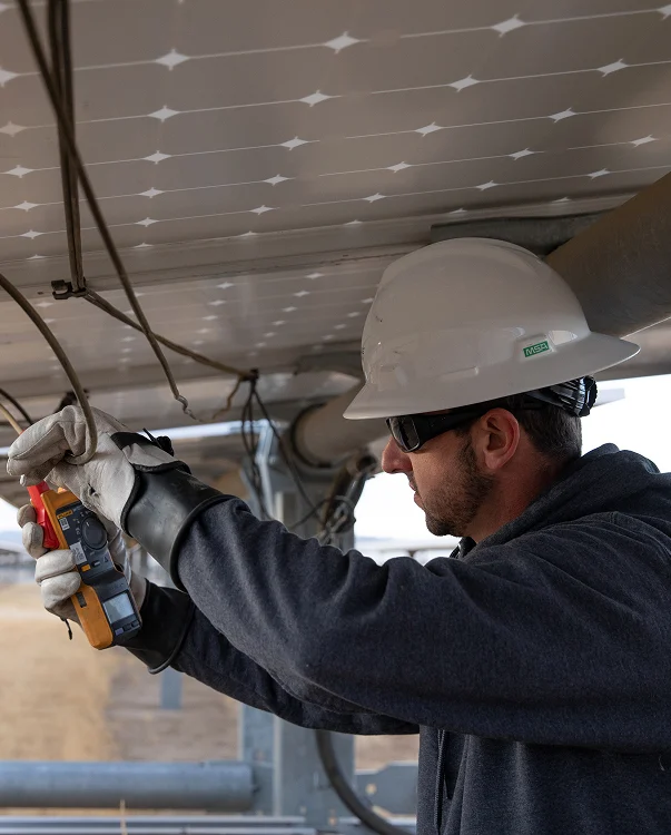 An electrician checking an industrial solar panel