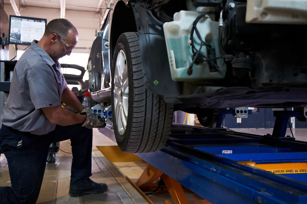 A mechanic from Caliber Collision working on a car