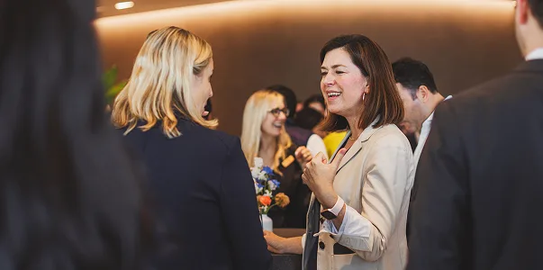 Two women talking in a crowd